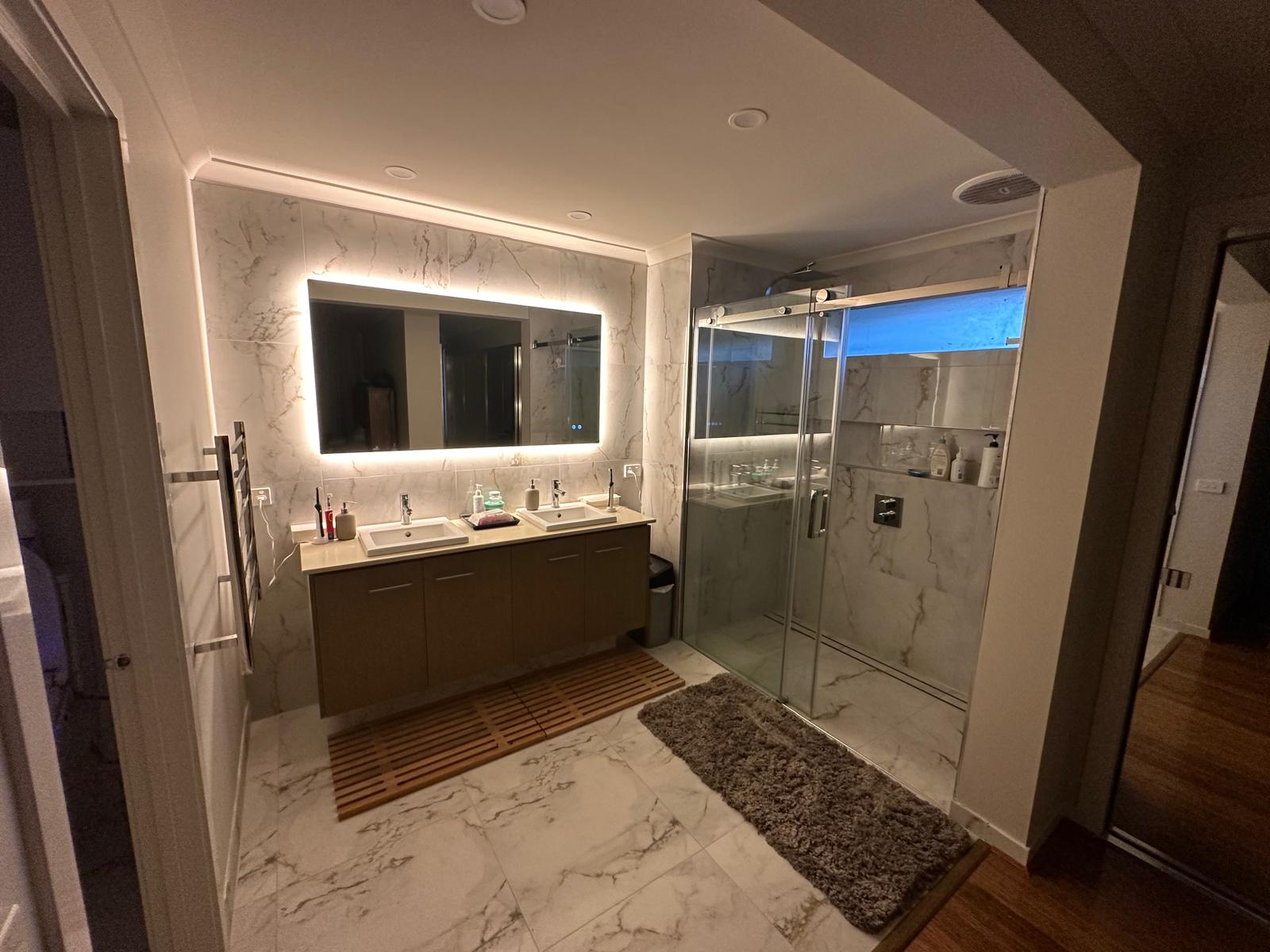 Night view of master bathroom highlighting ambient lighting